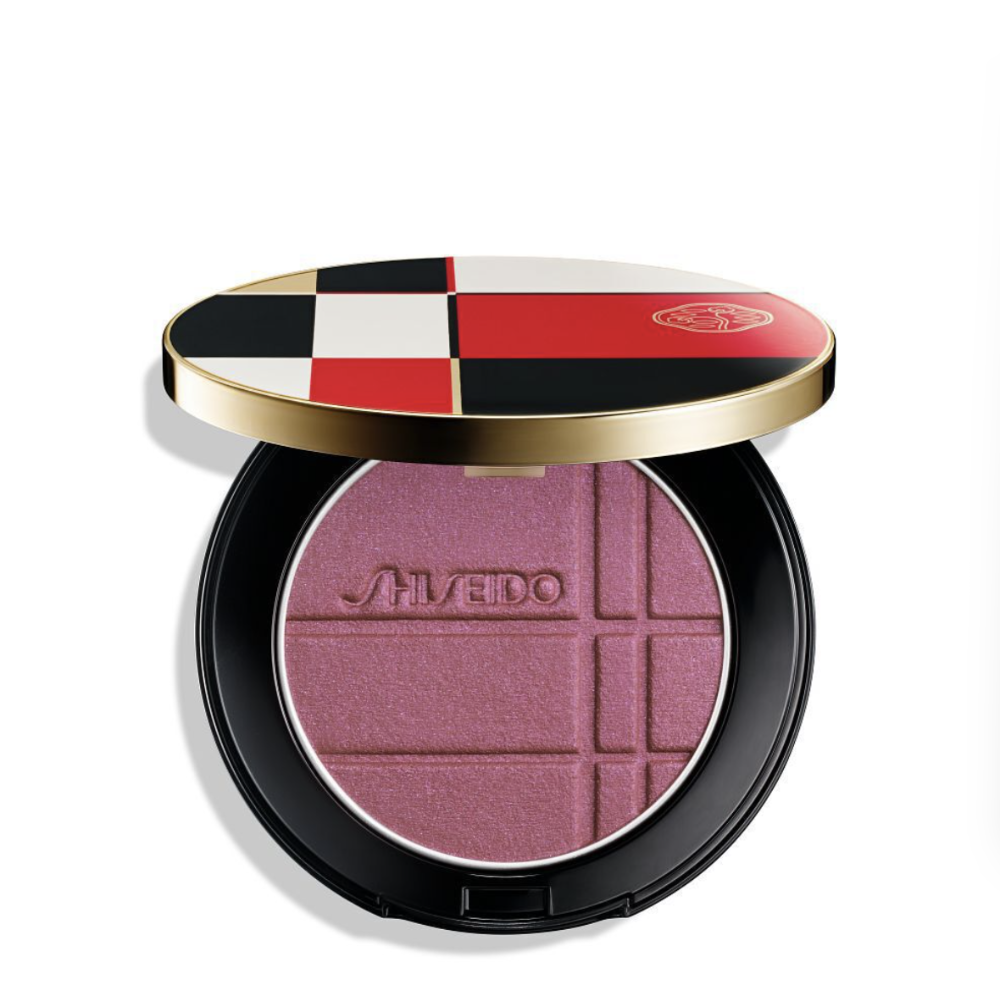Shiseido Pressed Powder Blush + color enahncer in a round black compact with a gold and multicolor checkered lid, shown open on a white background.