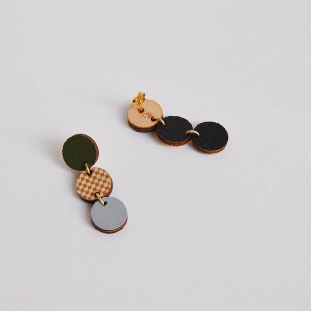 Multicolored circular earrings on a light gray background