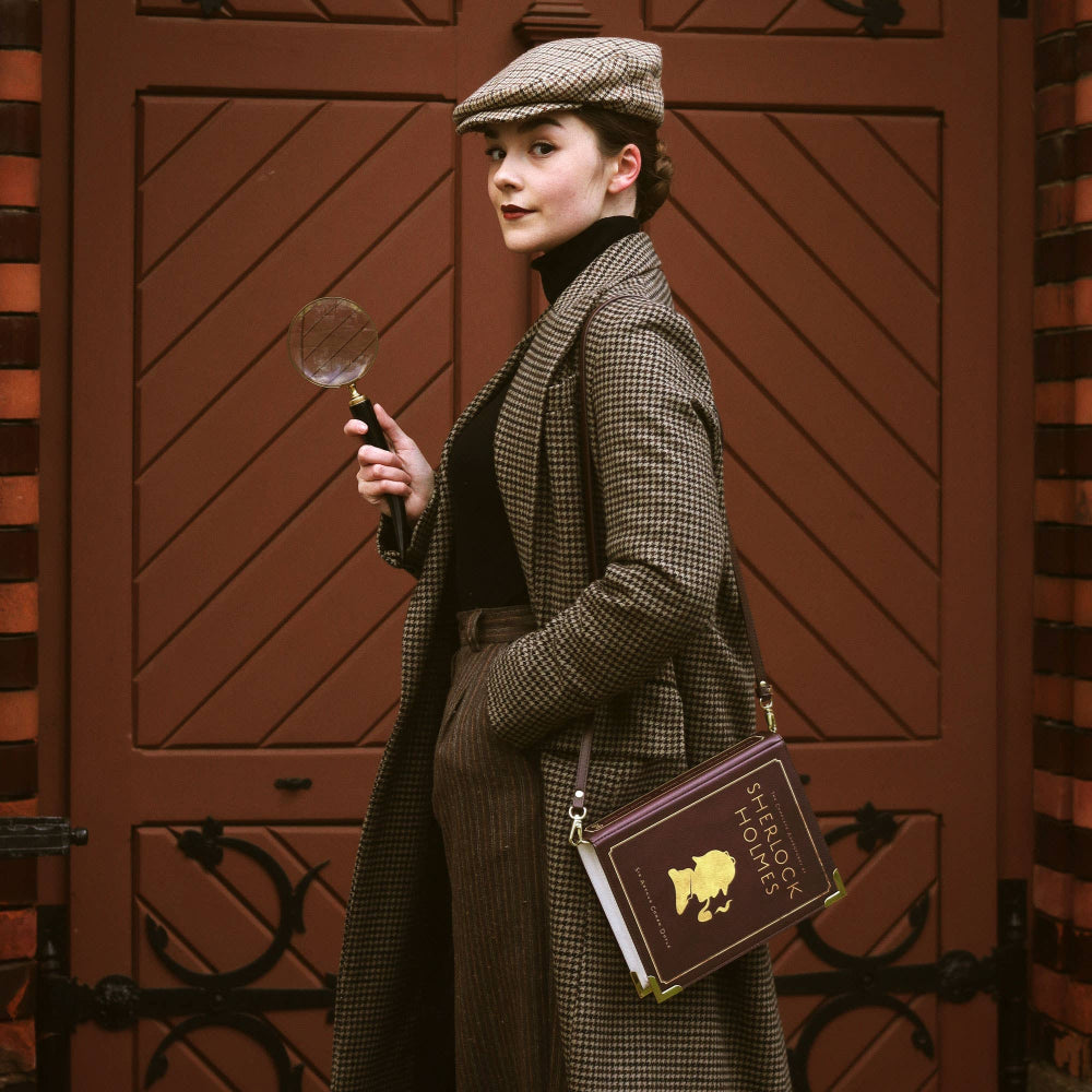 Woman in vintage attire with a magnifying glass and book against a brown door background