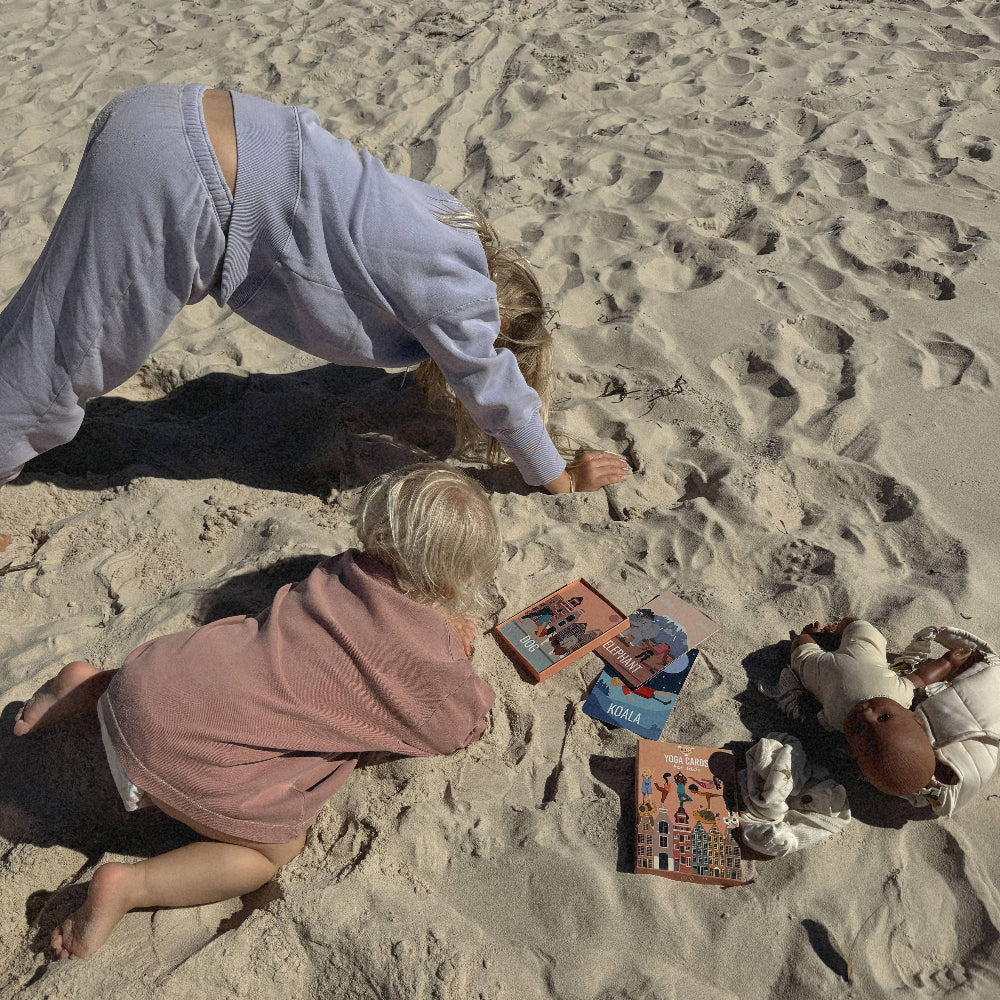 Two people playing with toys on a sandy beach