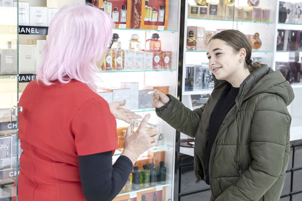 Two women testing luxury perfumes