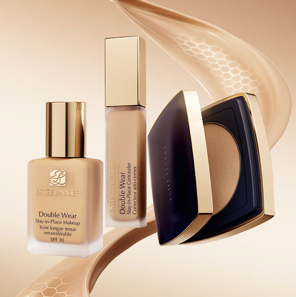 Estée Lauder makeup products including foundation and concealer on a beige background