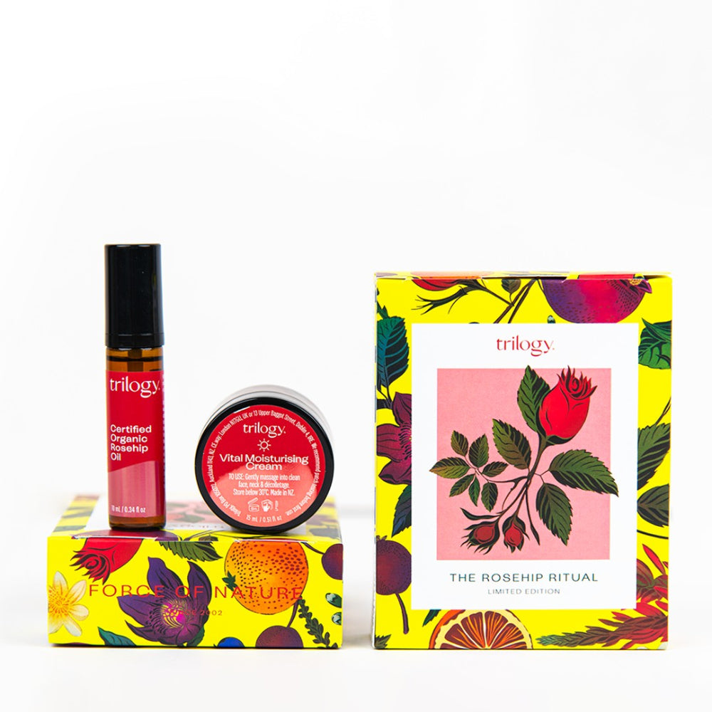 Trilogy beauty products with colorful packaging on a white background