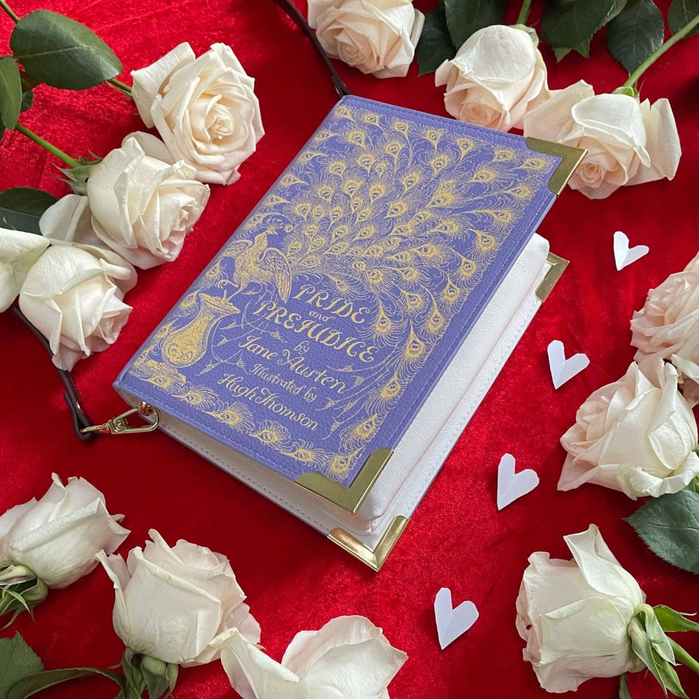 Book titled 'Pride and Prejudice' by Jane Austen surrounded by white roses on a red background