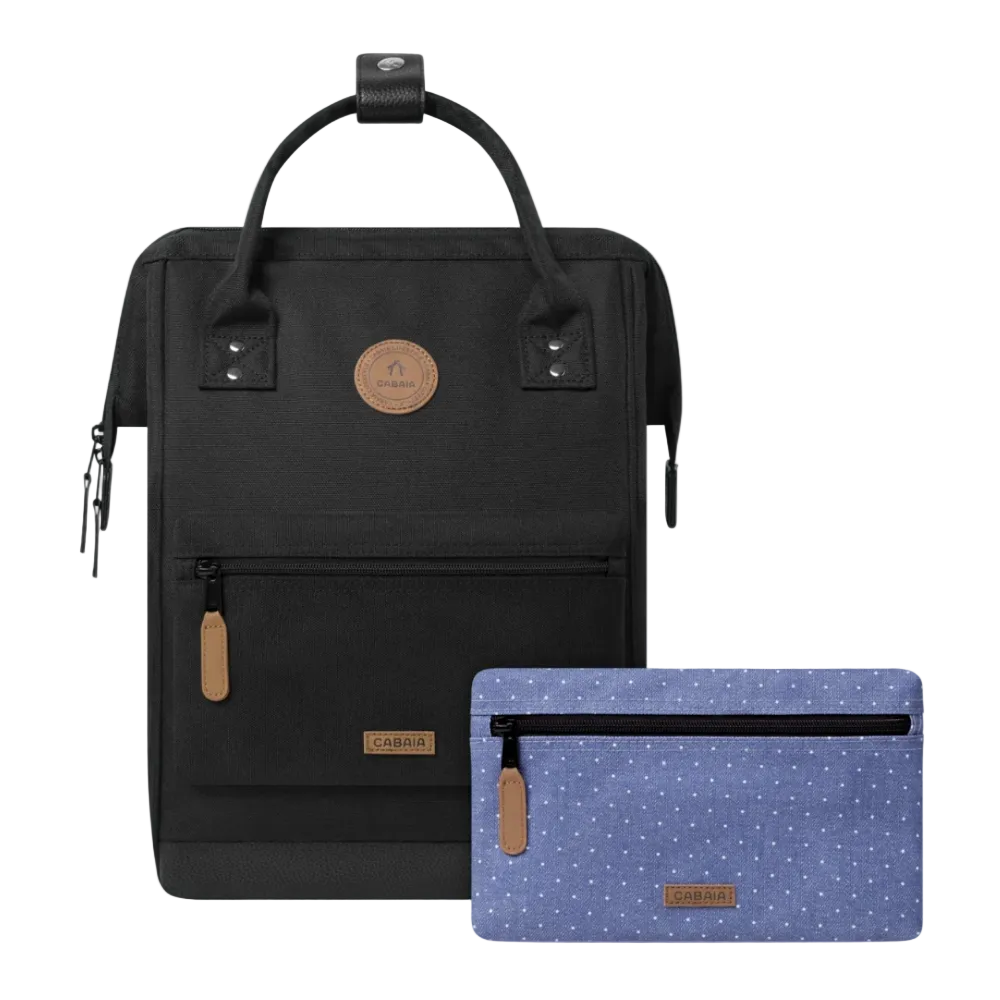 A black tote-style backpack shown with a matching zip pouch in front. The pouch is light blue with small white polka dots and has tan leather accents.