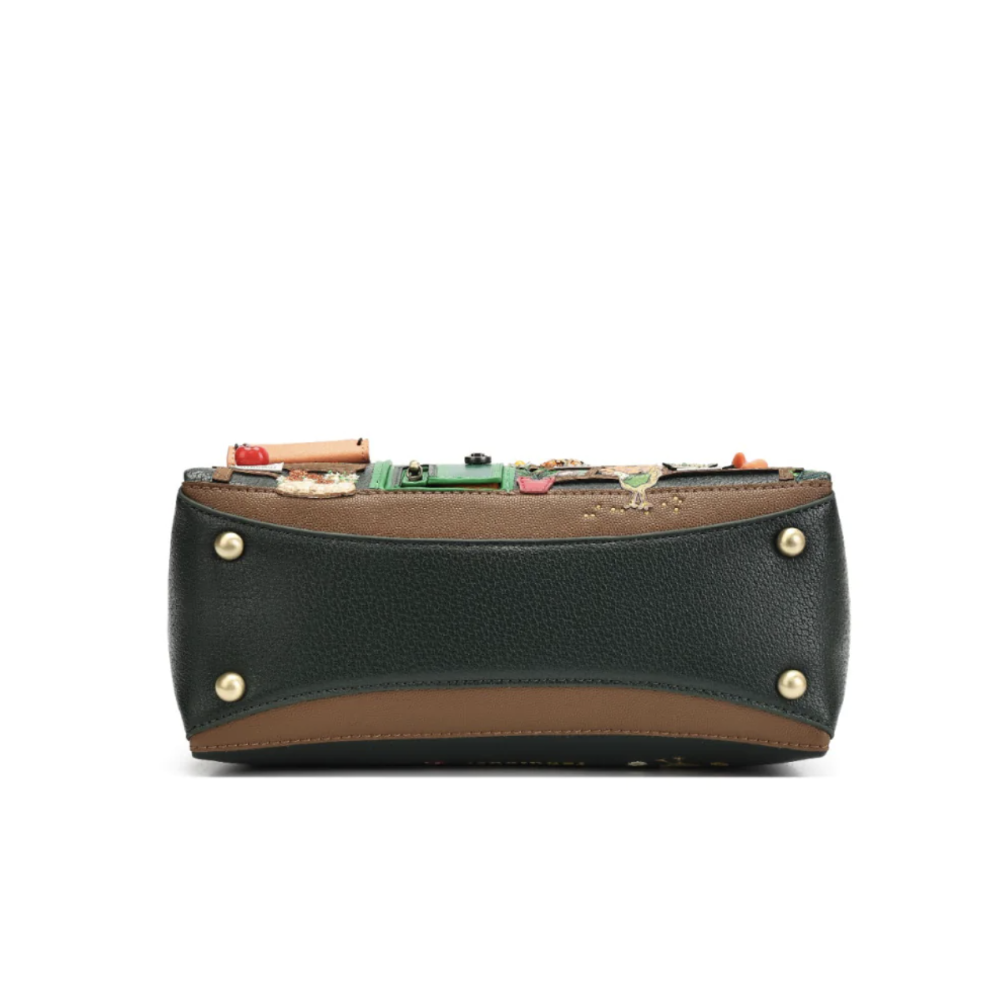 A structured leather clutch bag with a dark green pebbled texture, a tan leather trim, and gold-tone metal studs on the front, featuring a decorative collage of small colourful objects on the top flap, set against a plain white background.