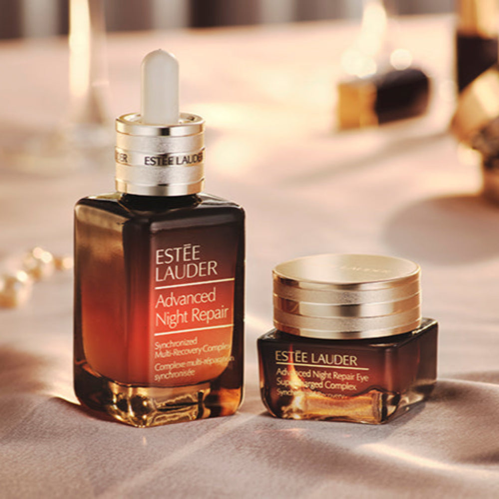 Estée Lauder Advanced Night Repair serum and eye cream on a soft surface