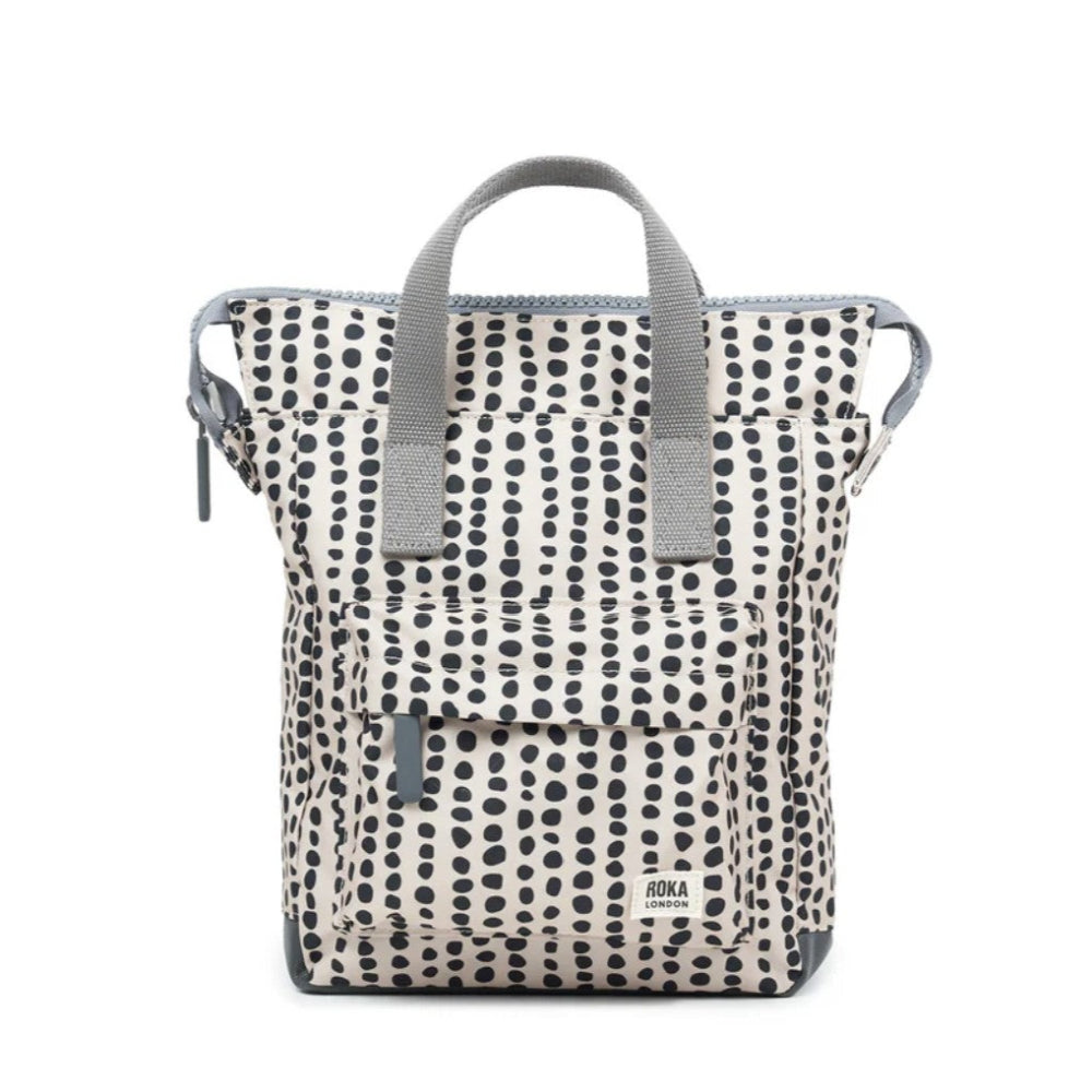 Backpack with black dot pattern on a white background