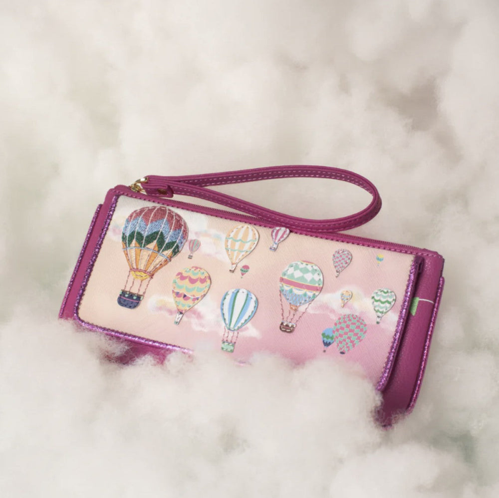 Pink wallet with hot air balloon design on a fluffy white background