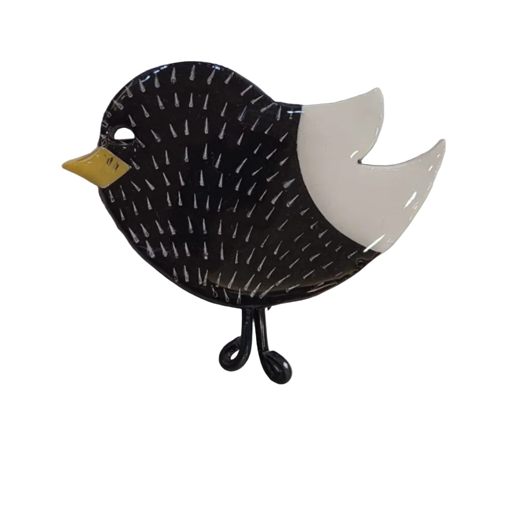 Black bird-shaped jewelry brooch pin on a white card with 'Fiona Herbst' branding.