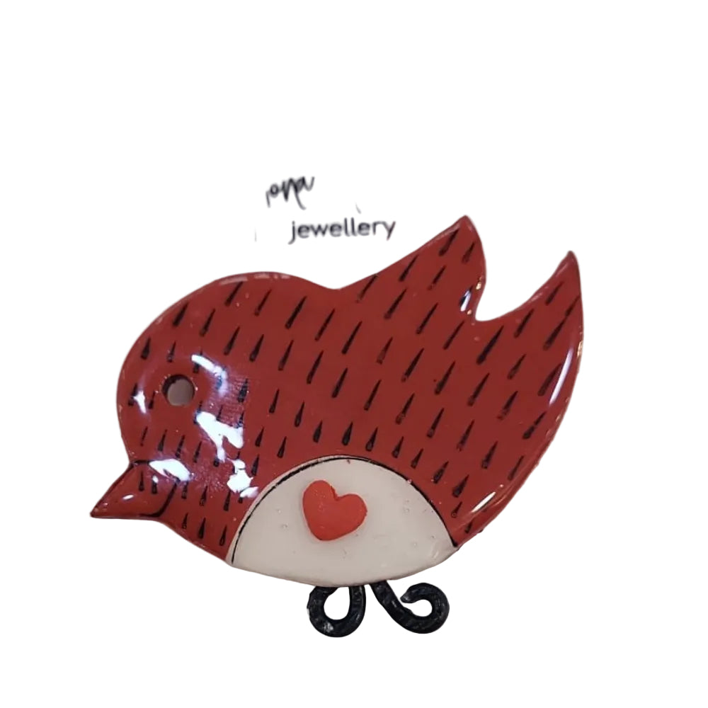 Red bird brooch on a white card with 'Fiona Herbst Jewellery' branding.