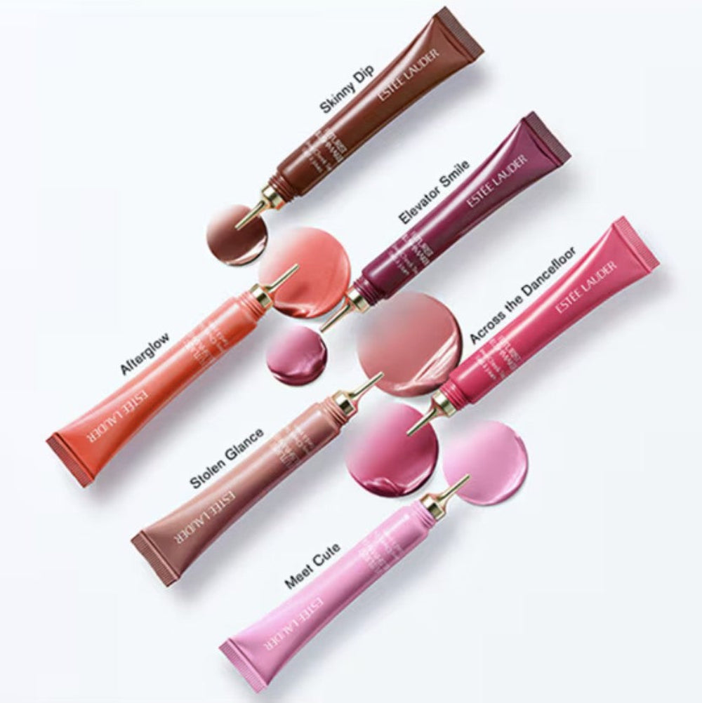Set of Estee Lauder cheek tint tubes with applicators on a white background