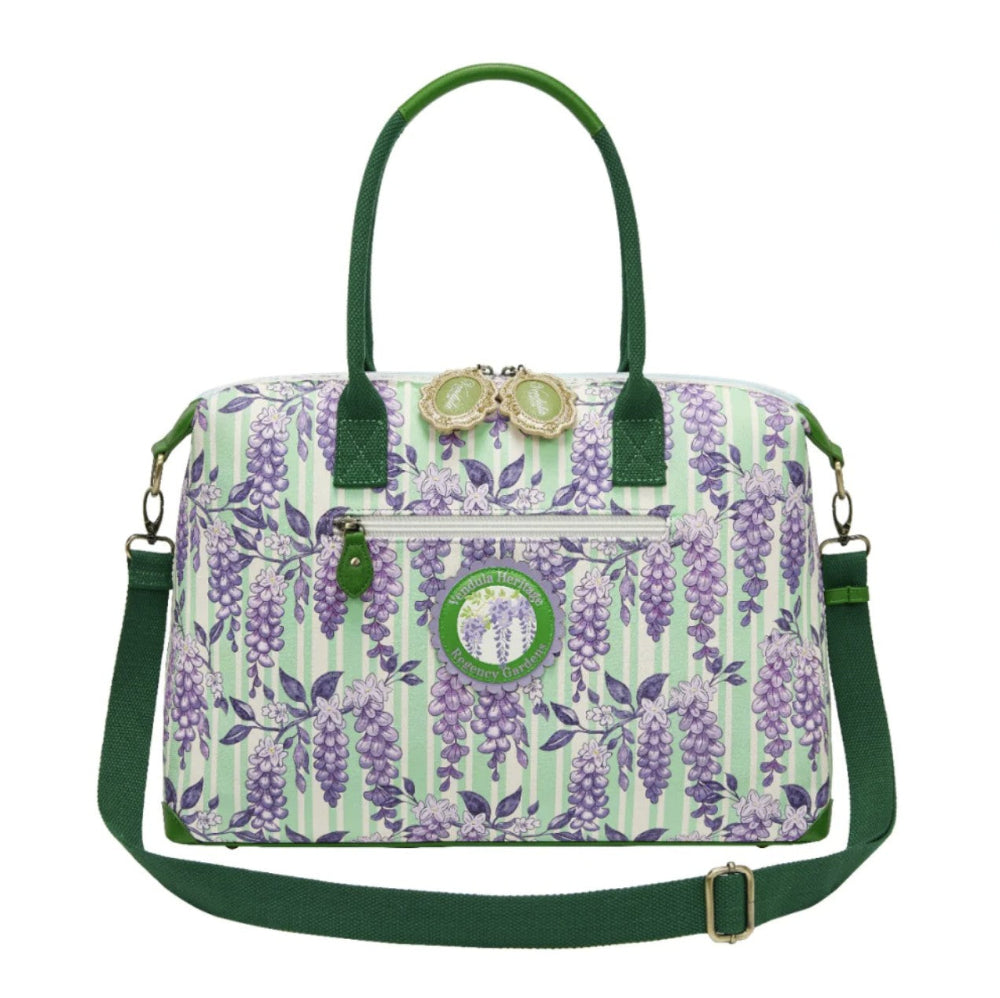 Floral patterned handbag with green accents on a white background