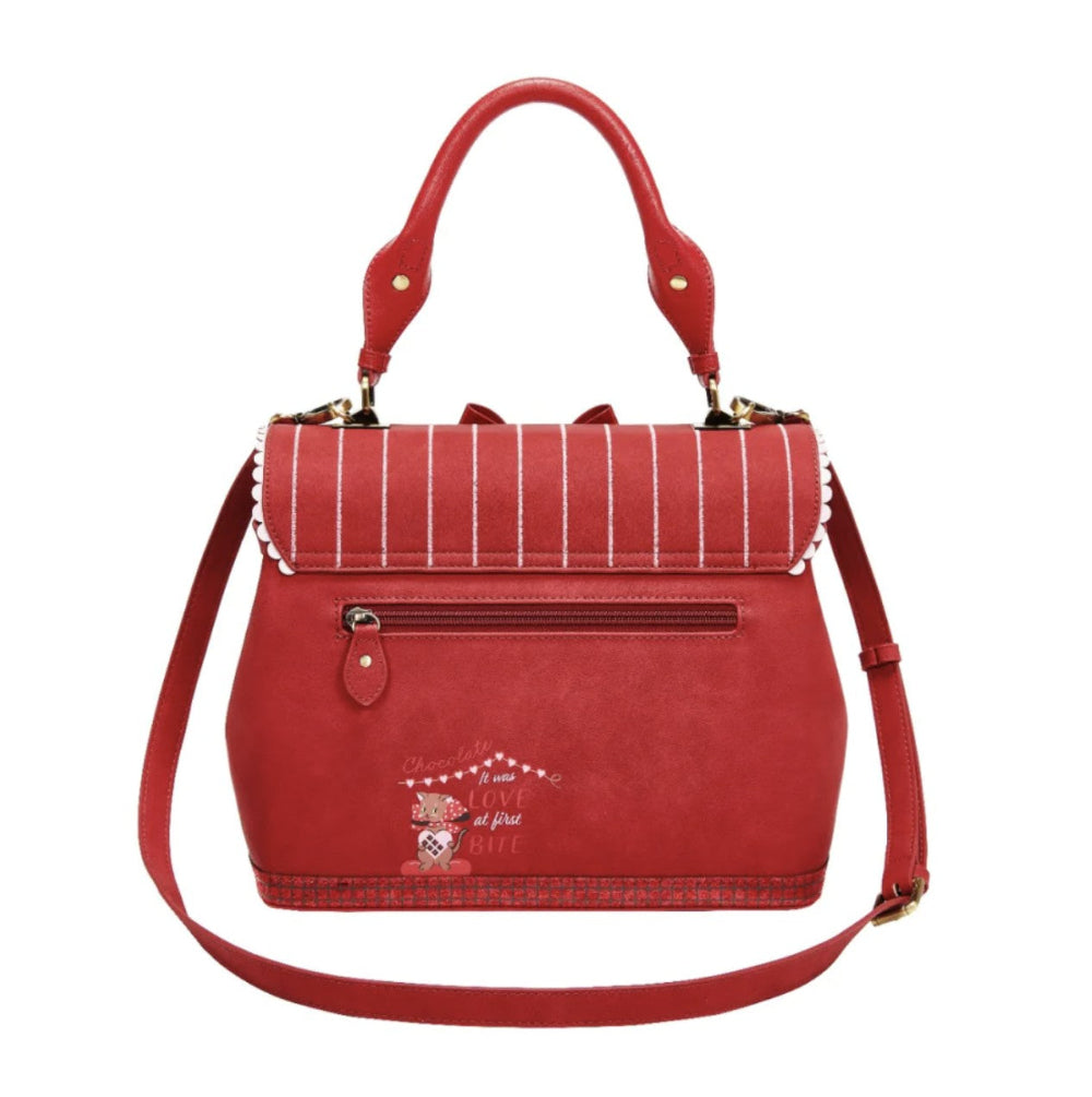 Red handbag with a decorative patch on a white background