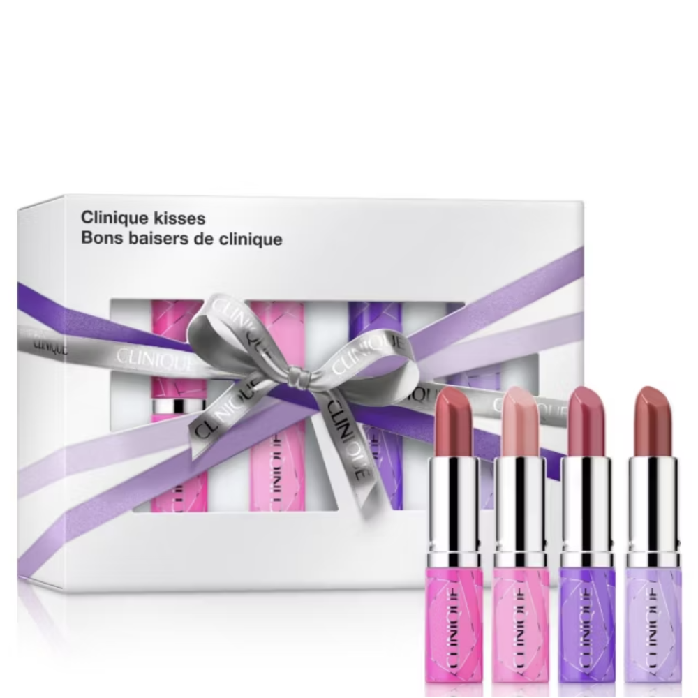 Clinique Kisses lipstick gift set featuring a white box with a purple ribbon and four individual lipsticks in pink, nude, purple, and mauve shades displayed in front.