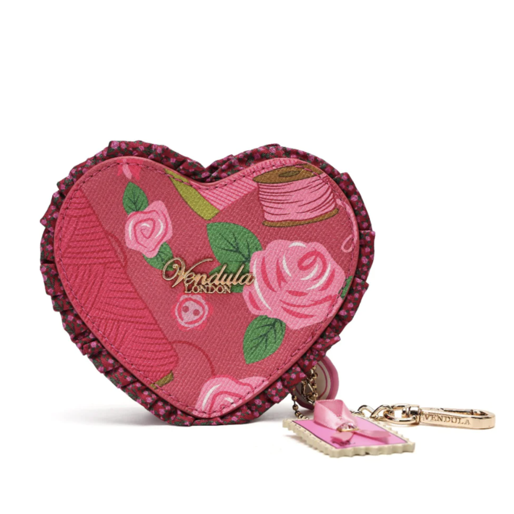 A heart-shaped pink keychain coin purse with a floral rose pattern, featuring the brand name 'Vendula London' in gold script. The pouch has a dark pink beaded edge and is shown with its attached pink bow charm and gold keyring on a clean white background.