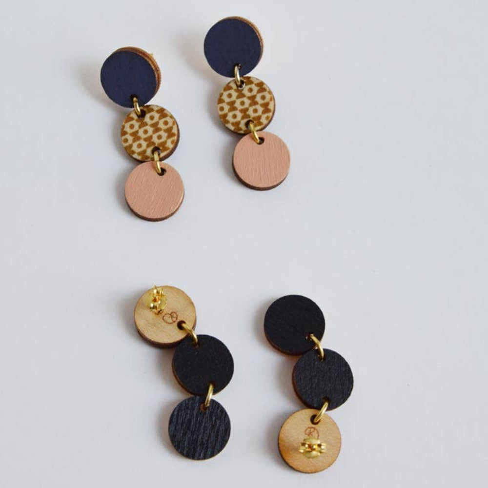 Pair of multicolored circular earrings on a light gray background