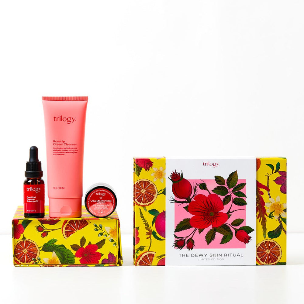 Trilogy skincare products with colorful packaging on a white background