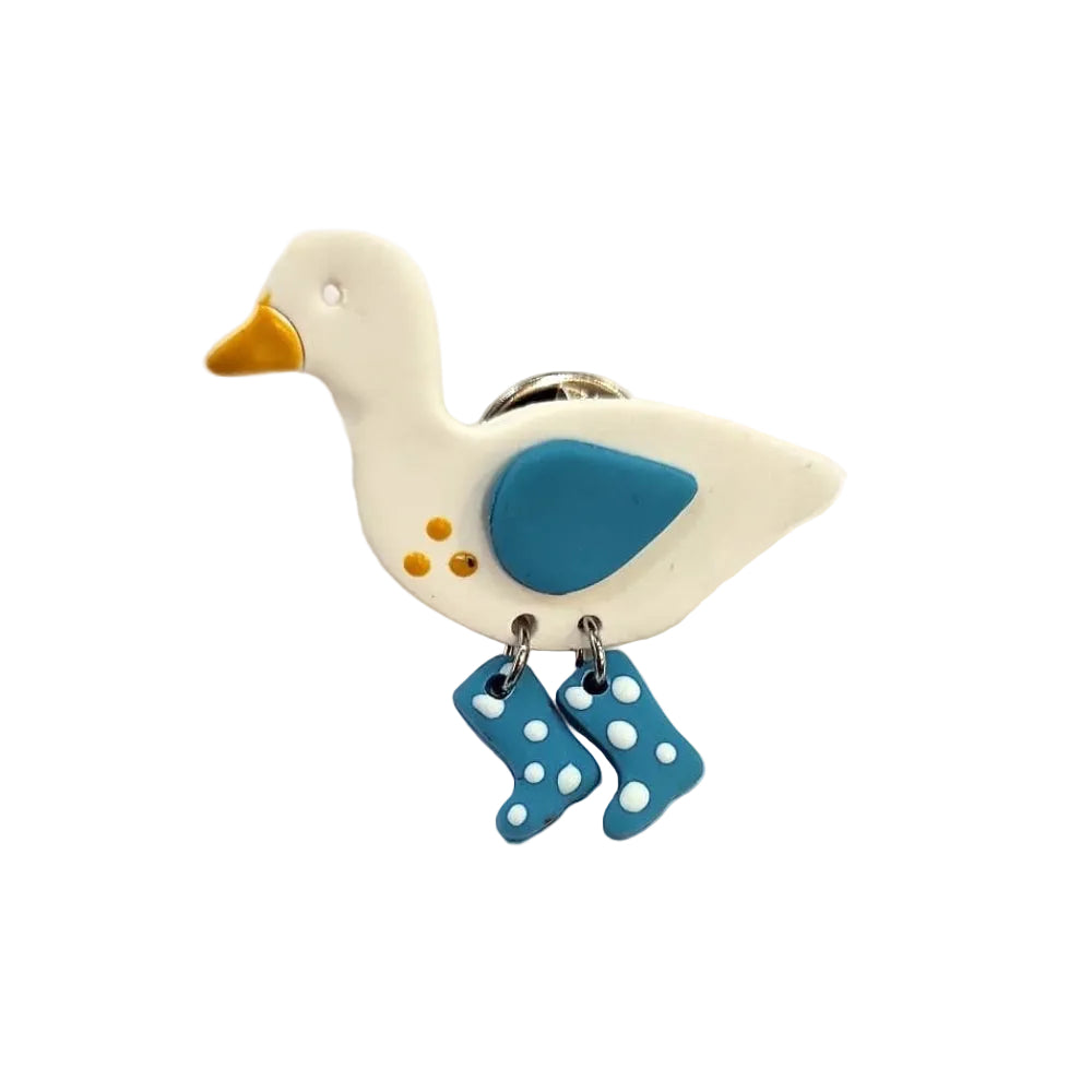 Decorative duck-shaped brooch pin with blue accents on a white background