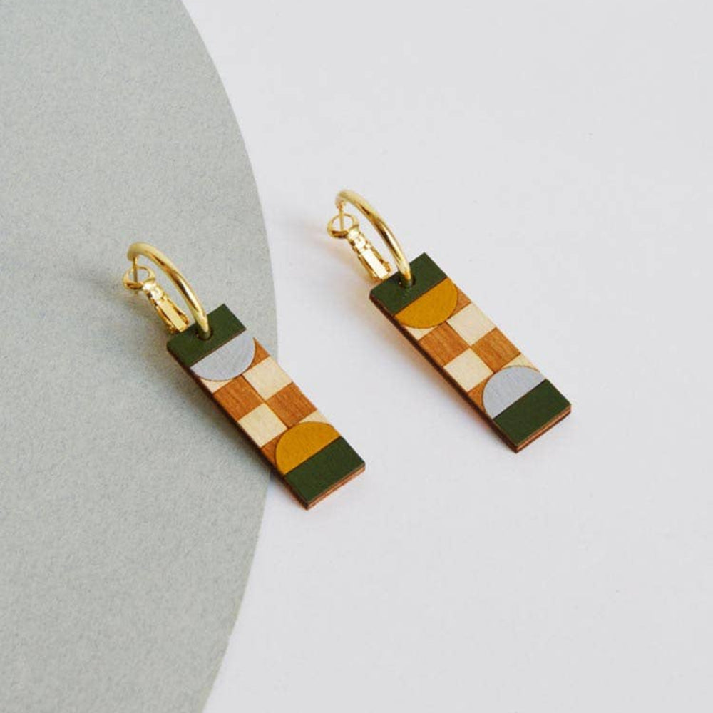 Geometric patterned earrings on a light gray background