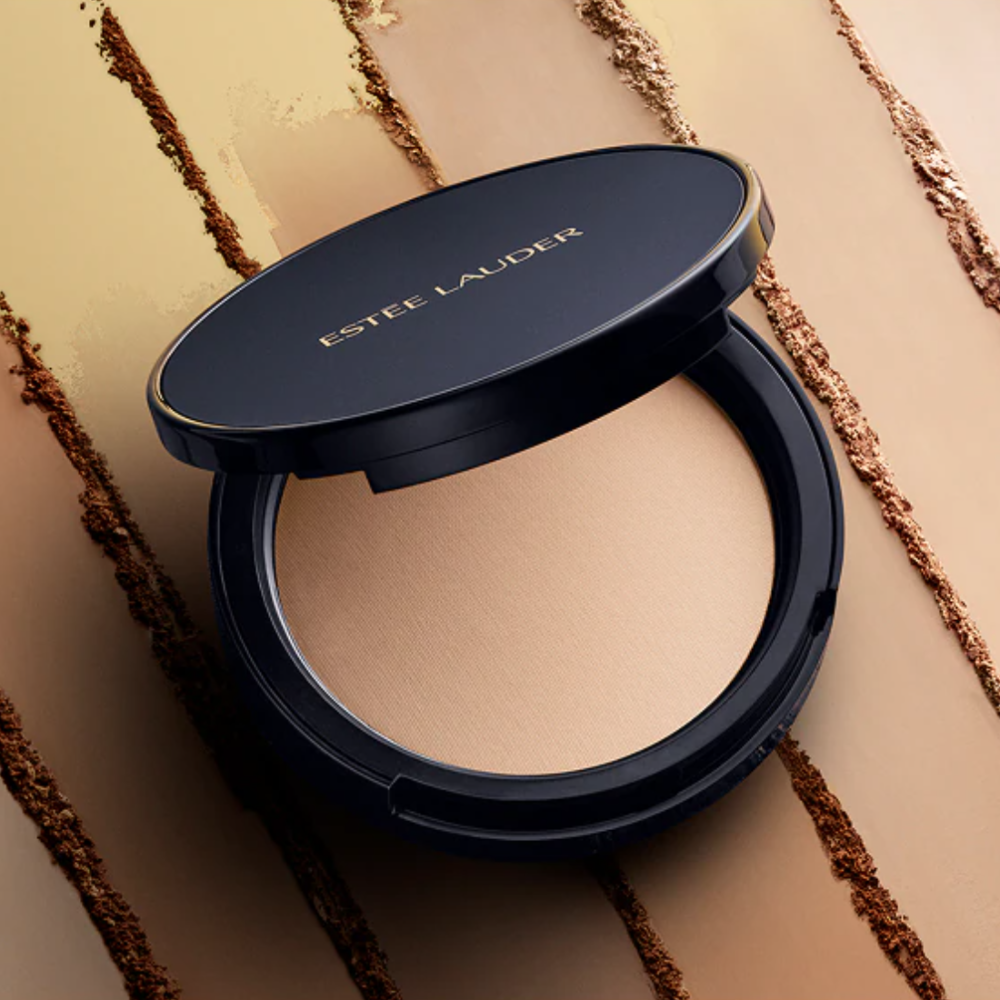 Estee Lauder compact powder on a beige background