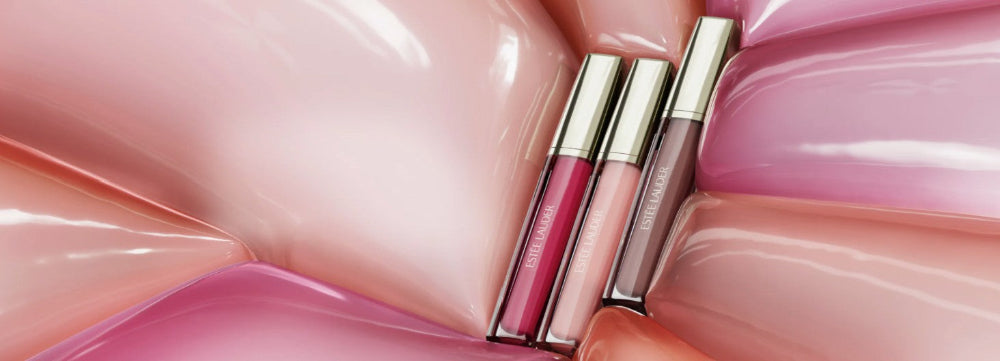 Two lip glosses on a pink and white swirled background