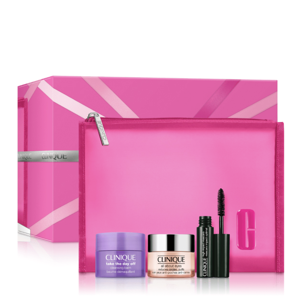 Clinique gift set featuring a pink zippered pouch, a large pink presentation box, a purple cleansing balm, a pink-and-silver Ultra-High-End cream jar, and a black mascara tube on a white background.