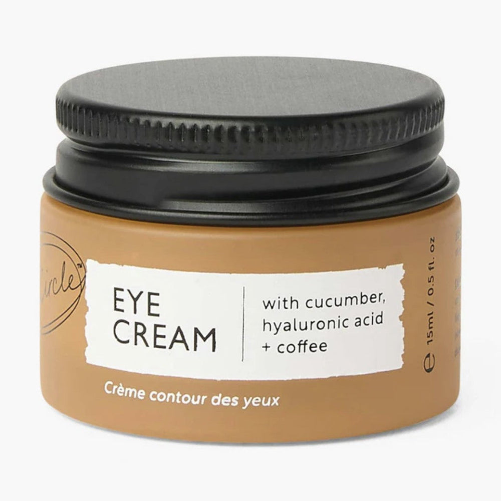Jar of eye cream with black lid on a white background