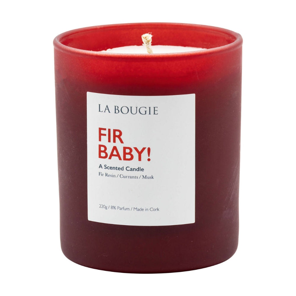Red candle with a white label reading 'Fir Baby!' by La Bougie on a white background