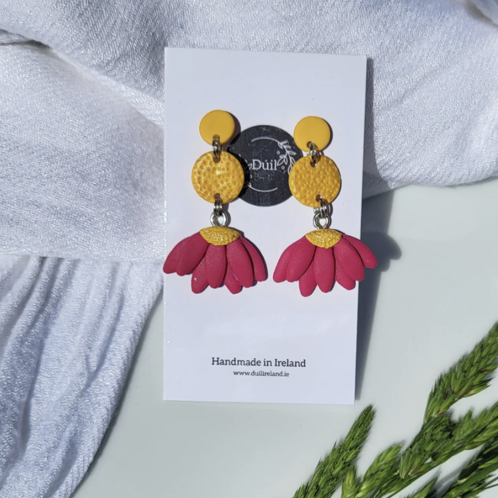 Floral earrings on a Duil branded card with a light background
