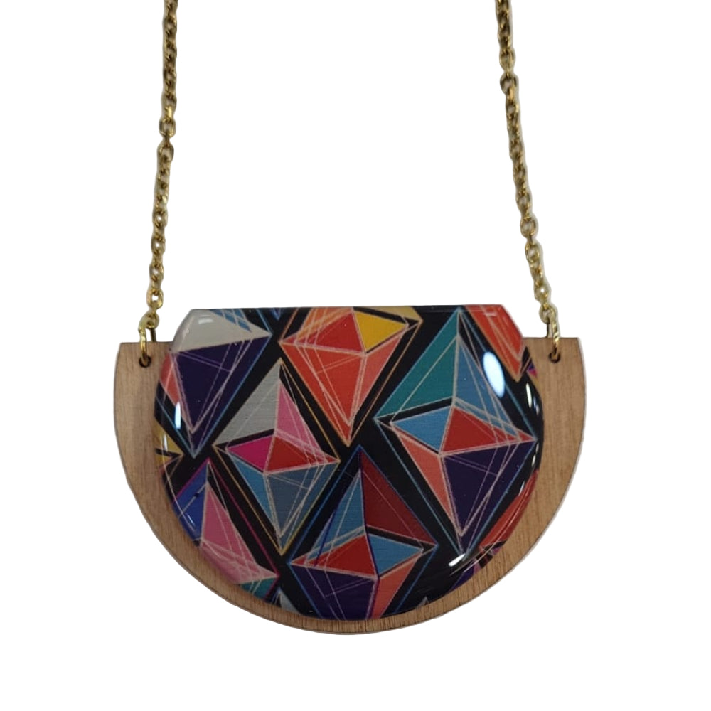 Colorful geometric-patterned handbag with a gold chain on a white background
