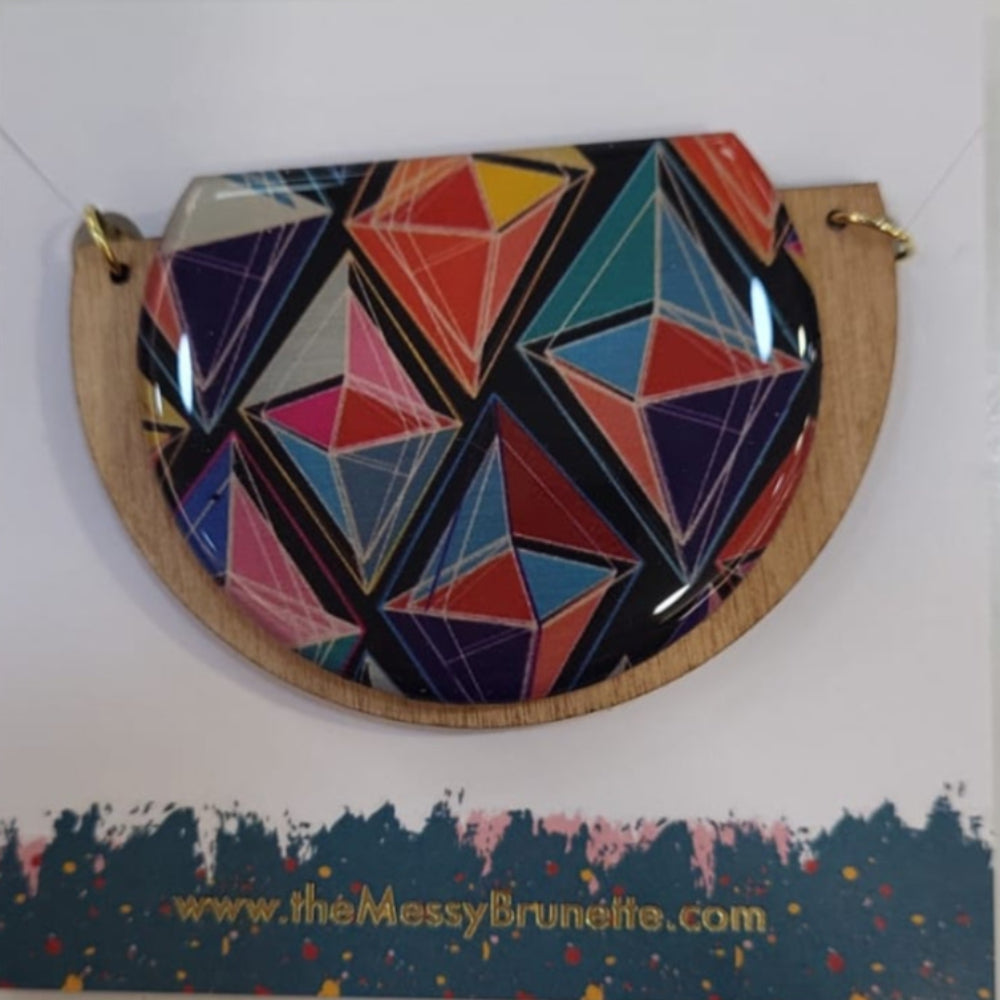 Colorful geometric-patterned coin purse on a white card with a website address.
