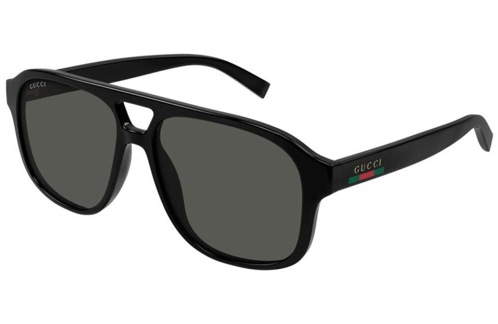 Gucci oversized aviator-style sunglasses with a glossy black frame and dark gray lenses, featuring the iconic green and red stripe detail on the temple arm.