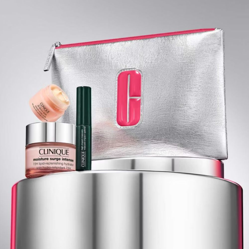 Clinique skincare products with a silver pouch on a reflective surface