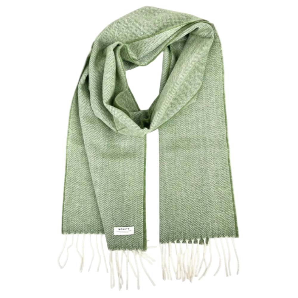 A sage green woven scarf with a subtle herringbone pattern, featuring cream-colored fringe ends.