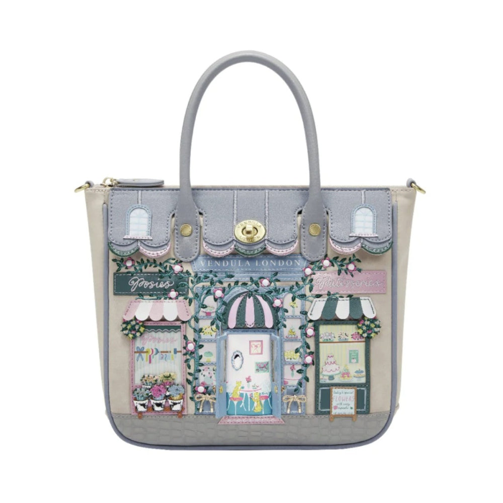 Handbag with a decorative design of shop fronts on a white background