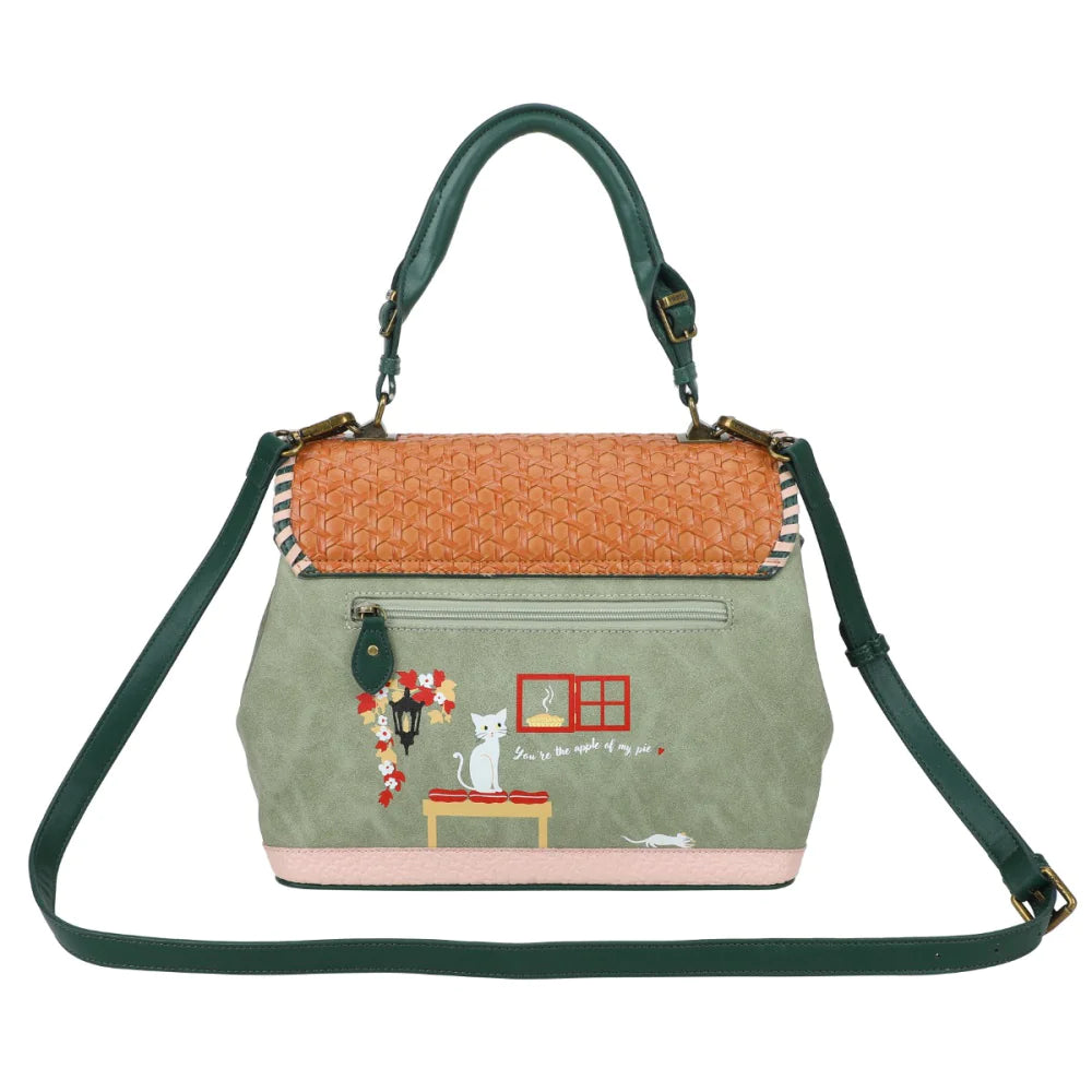 Handbag with green strap and embroidered design on a white background