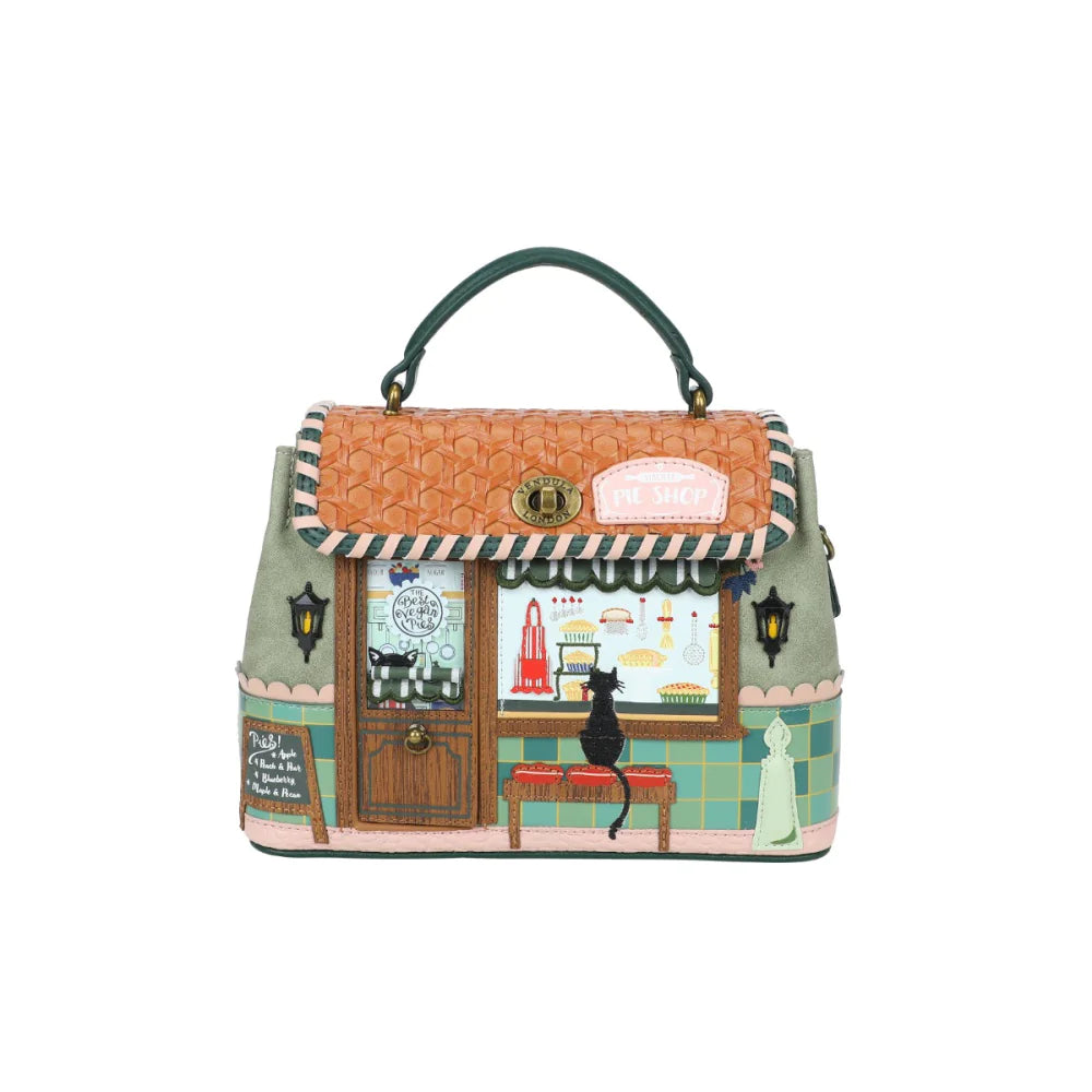Handbag with a design of a quaint store front and cat on a white background