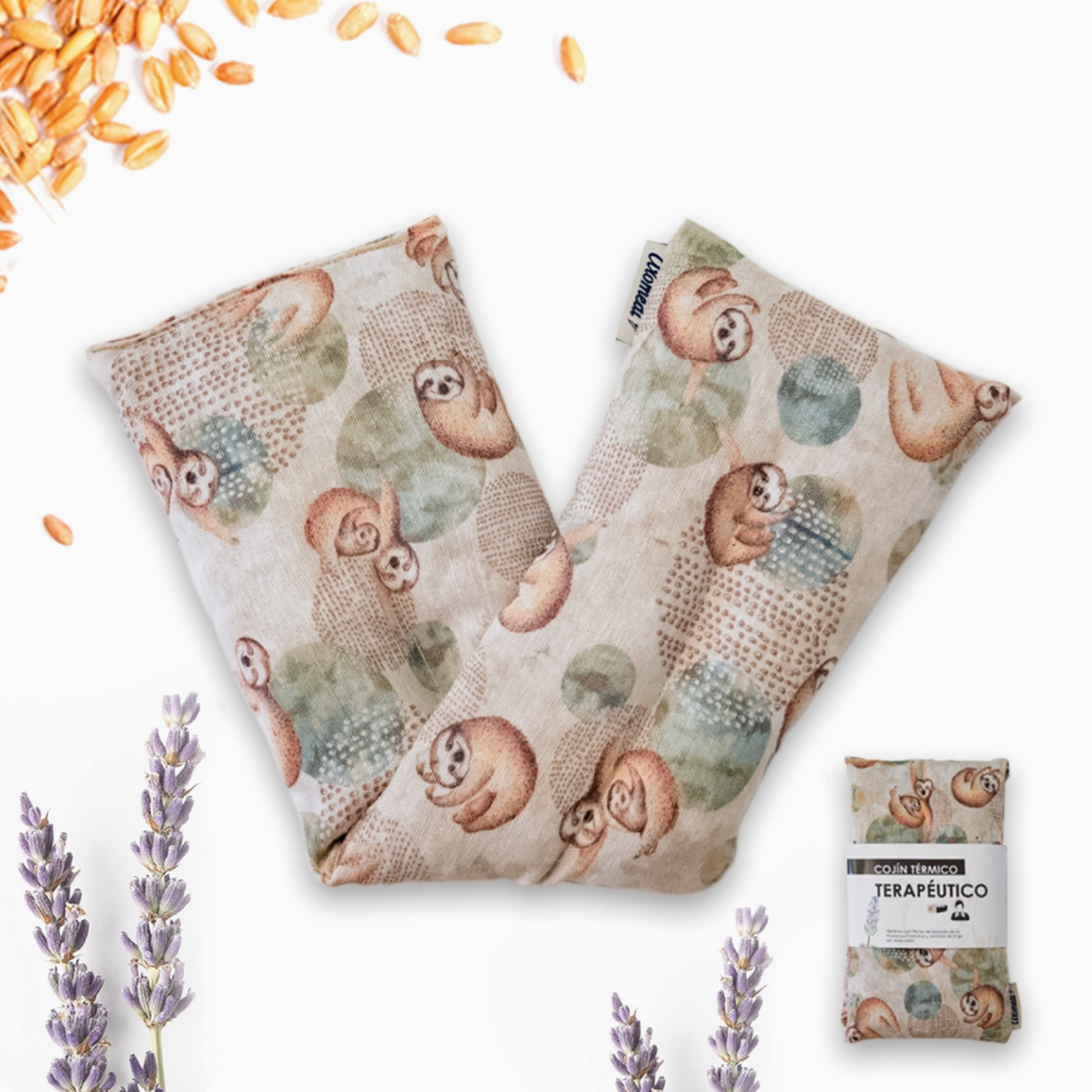 Two fabric bags with sloth pattern, surrounded by lavender flowers and scattered oats on a white background.