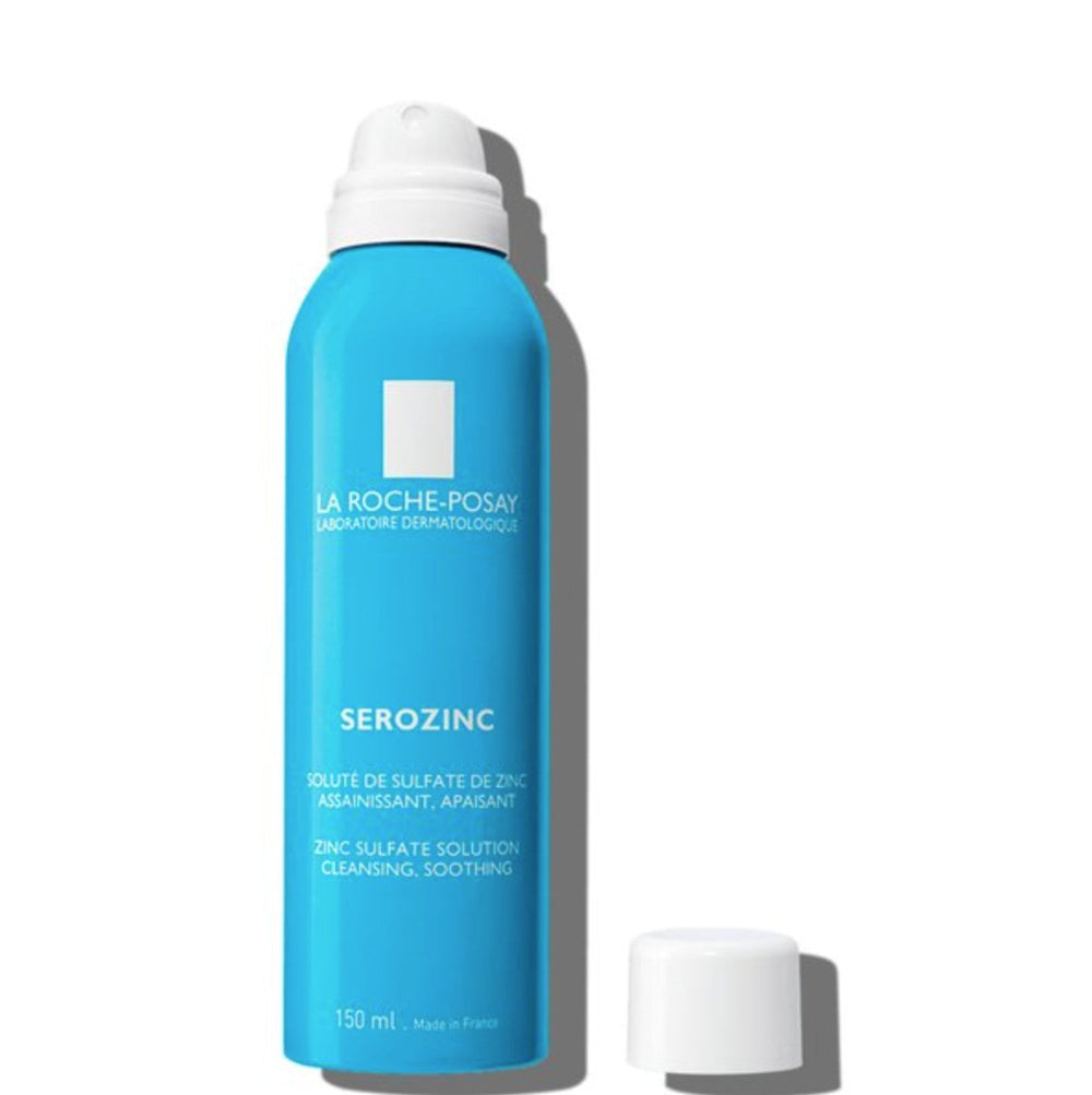 Blue spray bottle with white cap labeled 'La Roche-Posay' on a white background
