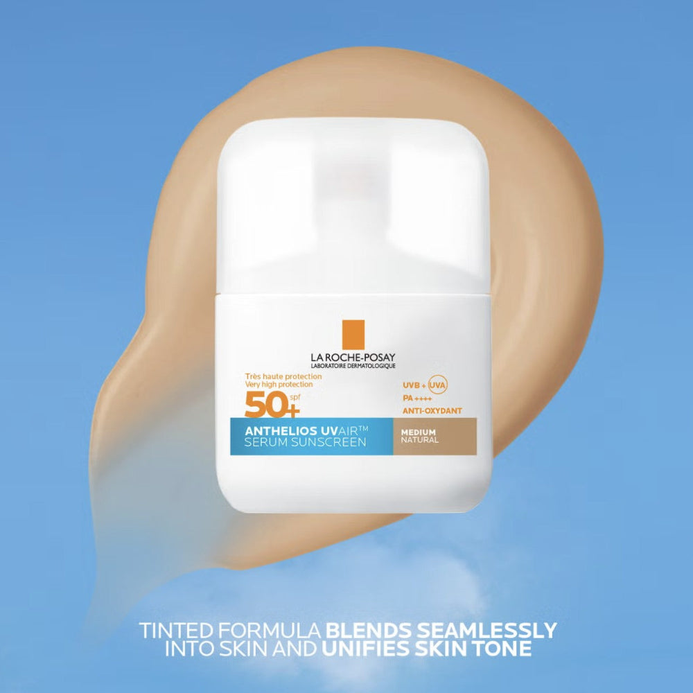 La Roche-Posay sunscreen bottle on a light medium swatch background with blue sky.