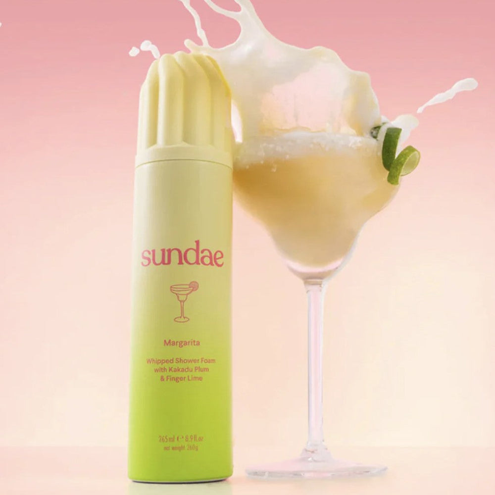 Sundae whipped shower foam with a glass of Margarita on a pink background