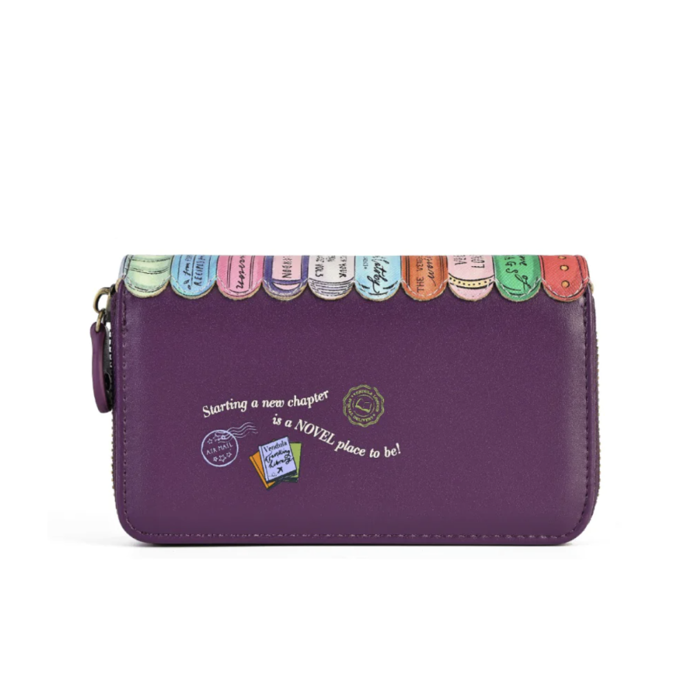 A purple zip-around wallet with a decorative top edge featuring colorful book spine designs and white script text on the front, shown on a plain white background.
