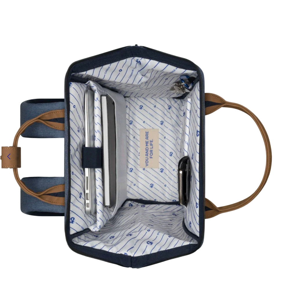 Open blue bag with brown handles on a white background