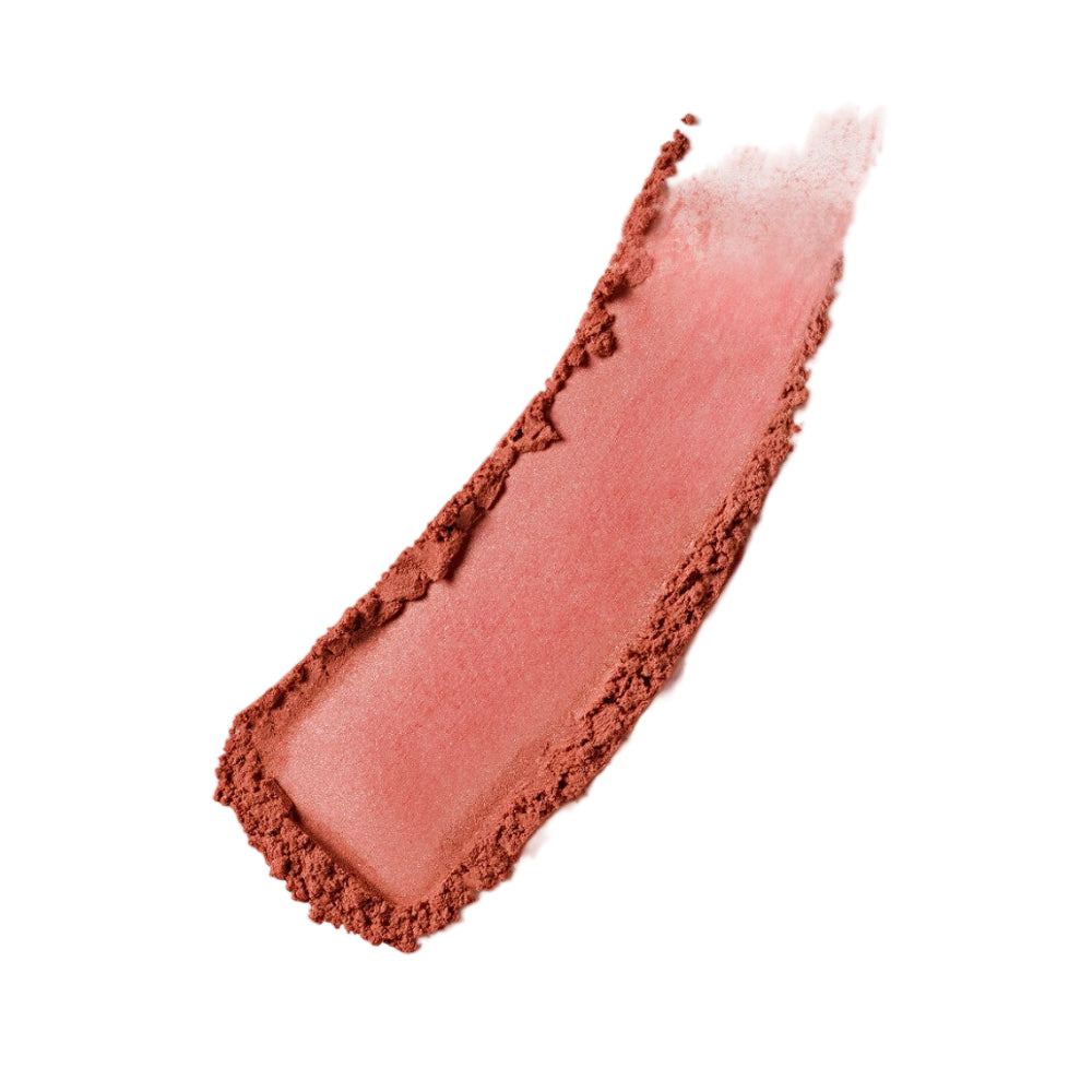 Close-up of a swatch of pink blush on a light gray background