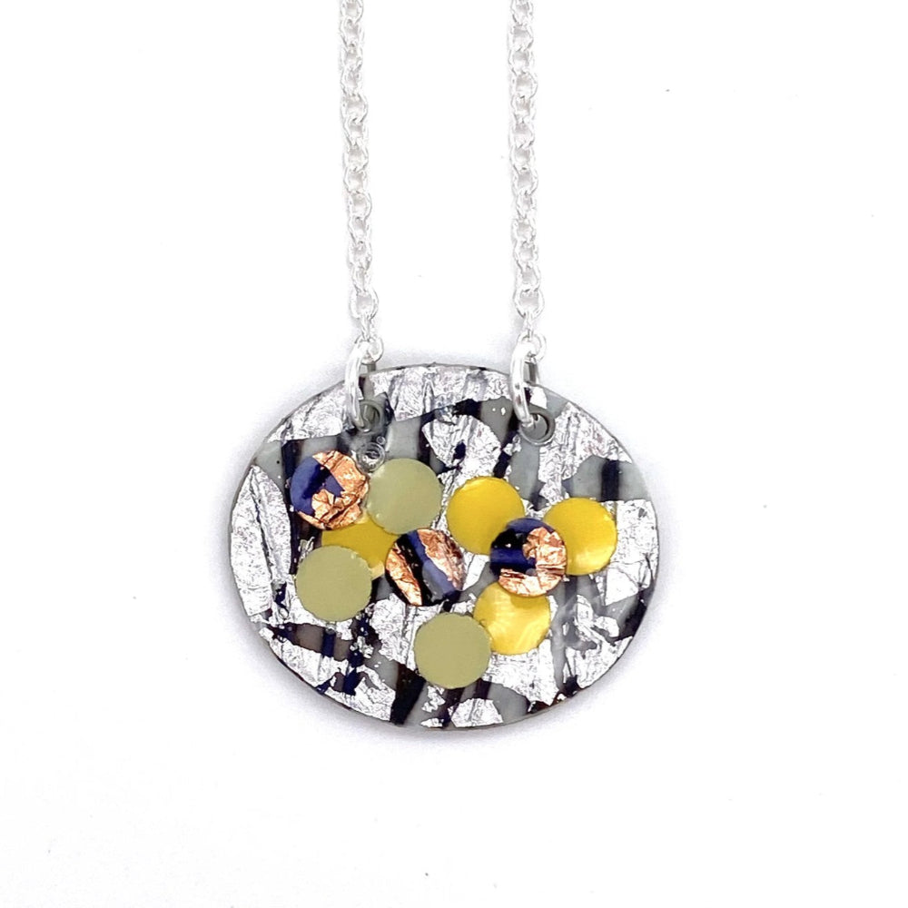 Necklace with a round pendant featuring colorful circular designs on a white background