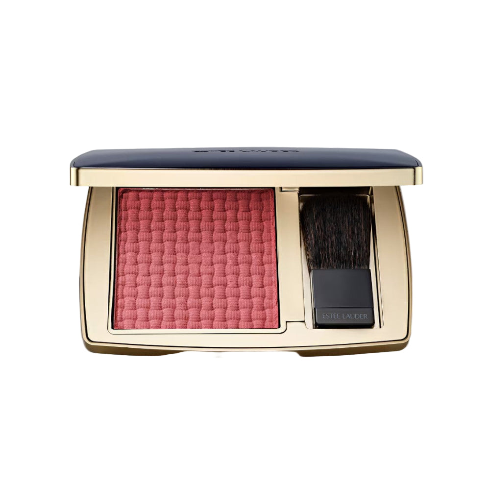 Compact blush with brush in a gold case on a white background