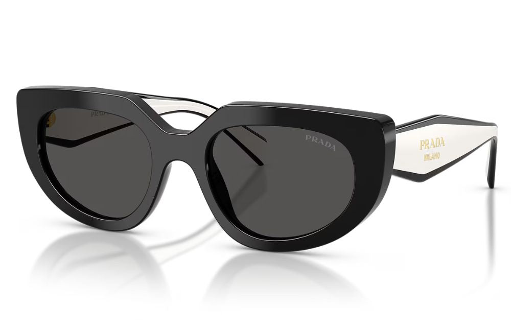 Prada sunglasses with a glossy black cat-eye frame, dark lenses, and white temples featuring gold Prada branding.
