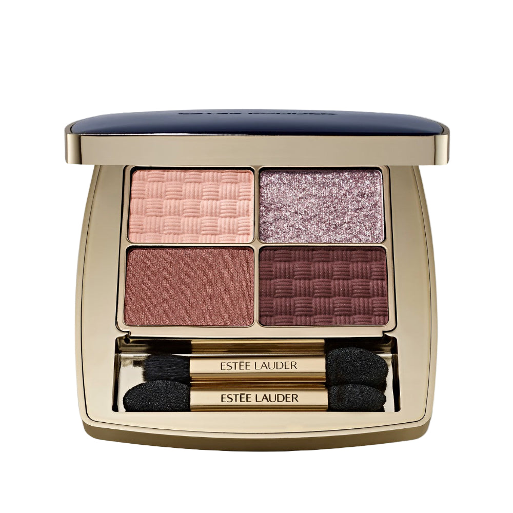 Estée Lauder eyeshadow palette with four shades and two brushes on a light gray background