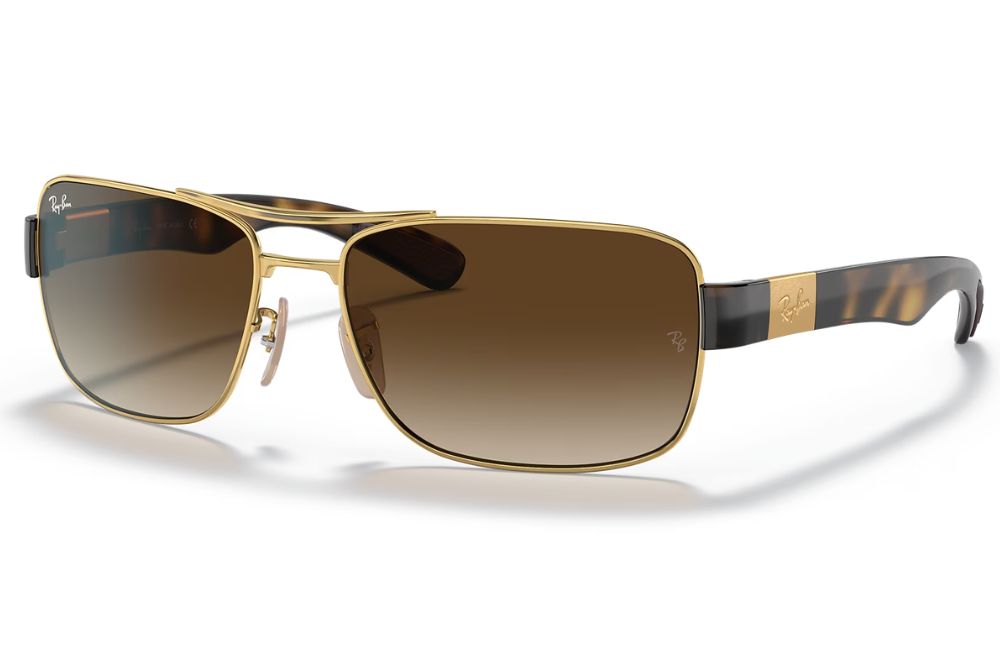 Gold-framed sunglasses with brown gradient lenses on a white background